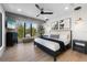 Modern bedroom with a king-sized bed, sleek furniture, stylish light fixtures, and a beautiful outdoor view at 540 S Polk Dr, Sarasota, FL 34236