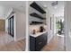 Hallway coffee station features marble countertop and built-in shelves with drinkware at 540 S Polk Dr, Sarasota, FL 34236