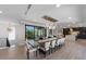Open concept dining room with a large dining table and modern chandelier lighting at 540 S Polk Dr, Sarasota, FL 34236