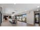 Open dining room with a large dining table, chandelier and sliding glass doors to the outside balcony at 540 S Polk Dr, Sarasota, FL 34236