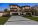 Eye-catching modern home with stone and wood accents, balconies, and a meticulously designed driveway and front yard at 540 S Polk Dr, Sarasota, FL 34236