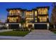 Nighttime exterior of a modern home featuring clean lines, dual garages, multiple balconies, and ample outdoor space at 540 S Polk Dr, Sarasota, FL 34236