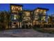 Nighttime back exterior of a modern home, featuring an outdoor seating area and a private fence surrounding the property at 540 S Polk Dr, Sarasota, FL 34236