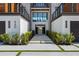 Inviting front entrance with a modern walkway, lush landscaping, and architectural design elements at 540 S Polk Dr, Sarasota, FL 34236