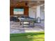Outdoor covered game room featuring a pool table, TV, and bar area for entertaining at 540 S Polk Dr, Sarasota, FL 34236
