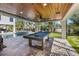 Elegant outdoor game room showcasing a billiards table, pool, and putting green for entertainment at 540 S Polk Dr, Sarasota, FL 34236