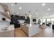 Open kitchen with large island, modern appliances, pendant lighting, and seamless flow to the living room at 540 S Polk Dr, Sarasota, FL 34236