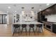 Spacious kitchen featuring a large island with bar stools, modern appliances, and stylish pendant lighting at 540 S Polk Dr, Sarasota, FL 34236