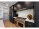 Kitchen featuring stainless steel range and hood with modern cabinetry and stone countertops at 540 S Polk Dr, Sarasota, FL 34236