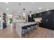 Modern kitchen with island seating, stainless appliances, custom cabinetry, and open layout at 540 S Polk Dr, Sarasota, FL 34236