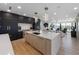 Open concept kitchen featuring an island, stainless appliances and lighting fixtures and views of the living area at 540 S Polk Dr, Sarasota, FL 34236