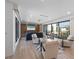Spacious living room with hardwood floors, recessed lighting, a large TV, and expansive windows with a view at 540 S Polk Dr, Sarasota, FL 34236