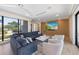 Cozy living room featuring a comfortable sofa, stylish decor, a large window, and a built-in entertainment center at 540 S Polk Dr, Sarasota, FL 34236