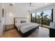 Cozy bedroom with large windows, a private balcony, and stylish lighting fixtures at 540 S Polk Dr, Sarasota, FL 34236
