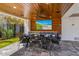 Inviting outdoor dining space with a table setting, a covered patio, and a mounted television at 540 S Polk Dr, Sarasota, FL 34236