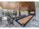 Outdoor living space featuring a shuffleboard table, comfortable seating, a pool, and a bar at 540 S Polk Dr, Sarasota, FL 34236