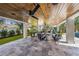 Outdoor living space showcasing a stained wood ceiling, tile flooring, pool table, and comfortable seating at 540 S Polk Dr, Sarasota, FL 34236
