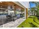 Expansive outdoor living area with a dining table, pool table, mini golf, and beautiful landscaping at 540 S Polk Dr, Sarasota, FL 34236