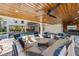 Inviting outdoor living space with a covered seating area, swimming pool, and an outdoor bar for relaxation and entertainment at 540 S Polk Dr, Sarasota, FL 34236