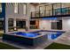 A stunning outdoor pool and spa with elegant tiling and an adjacent outdoor entertainment area featuring a pool table at 540 S Polk Dr, Sarasota, FL 34236