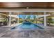Tranquil pool area with a spa, covered patio, and outdoor seating, ideal for relaxation and entertainment at 540 S Polk Dr, Sarasota, FL 34236