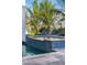 Backyard with pool and lounge chairs, complemented by lush tropical landscaping at 540 S Polk Dr, Sarasota, FL 34236