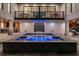 A beautifully lit pool and spa area with a waterfall, complemented by outdoor entertainment spaces and modern design at 540 S Polk Dr, Sarasota, FL 34236