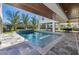 Stylish pool area featuring a spa, modern patio, and views of the surrounding lush landscaping at 540 S Polk Dr, Sarasota, FL 34236