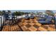 Roof top deck with deck chairs and dark wood tiles in a checkered pattern at 540 S Polk Dr, Sarasota, FL 34236