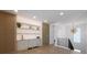 Wet bar featuring wood paneling, stone countertops, shelving with lighting, and wood-look tile flooring at 540 S Polk Dr, Sarasota, FL 34236