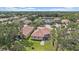 Aerial view of property showcasing the serene pond, screened-in lanai, and lush green landscaping at 5624 Aaron Ct, Sarasota, FL 34232