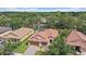Aerial view of home with a tile roof, 2-car garage, and a private backyard overlooking a scenic pond at 5624 Aaron Ct, Sarasota, FL 34232