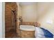 Bathroom featuring a soaking tub, a walk-in shower, and travertine tile at 5624 Aaron Ct, Sarasota, FL 34232