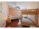Cozy bedroom features a full and bunk bed, rich wood floors, ceiling fan, and plenty of natural light at 5624 Aaron Ct, Sarasota, FL 34232