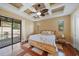 Bright bedroom with decorative ceiling fan, light walls, and access to pool area at 5624 Aaron Ct, Sarasota, FL 34232