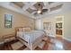 Bedroom featuring a decorative ceiling, light walls, and a view to the ensuite at 5624 Aaron Ct, Sarasota, FL 34232