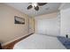 Bedroom with built-in shelving, closet, hardwood floors, and a nice view of the backyard at 5624 Aaron Ct, Sarasota, FL 34232
