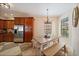 Cozy dining area with natural light, stainless steel appliances, and rustic chandelier at 5624 Aaron Ct, Sarasota, FL 34232