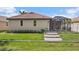 Beautiful single-story home with a tile roof, lush landscaping, and screened-in lanai with a pool at 5624 Aaron Ct, Sarasota, FL 34232