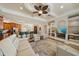 Open-concept living room with coffered ceiling, views of the kitchen, and built in shelves at 5624 Aaron Ct, Sarasota, FL 34232