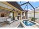 Relaxing screened-in lanai with a private jacuzzi and outdoor kitchen with a built-in grill at 5624 Aaron Ct, Sarasota, FL 34232