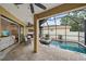Beautiful screened-in pool with a heated spa, covered seating area, and an outdoor kitchen at 5624 Aaron Ct, Sarasota, FL 34232