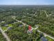 Neighborhood view of a house surrounded by trees at 5672 Jonesboro Ave, North Port, FL 34288