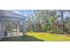 Lush backyard with a covered patio, ideal for enjoying nature at 5672 Jonesboro Ave, North Port, FL 34288