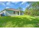Green backyard featuring a grassy lawn and mature trees at 5672 Jonesboro Ave, North Port, FL 34288