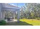 Expansive backyard features a covered patio with dining set, perfect for outdoor entertaining at 5672 Jonesboro Ave, North Port, FL 34288