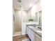 Modern bathroom featuring double sinks, granite countertops, and a glass-enclosed shower at 5672 Jonesboro Ave, North Port, FL 34288