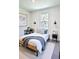 Neutral bedroom with a comfy bed, stylish side tables, and plenty of natural light at 5672 Jonesboro Ave, North Port, FL 34288