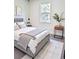 Well-lit bedroom features a comfortable queen-sized bed with a decorative throw and modern decor at 5672 Jonesboro Ave, North Port, FL 34288
