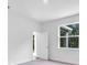 Bright bedroom features neutral colored carpet, a large window, and access to an ensuite bathroom at 5672 Jonesboro Ave, North Port, FL 34288